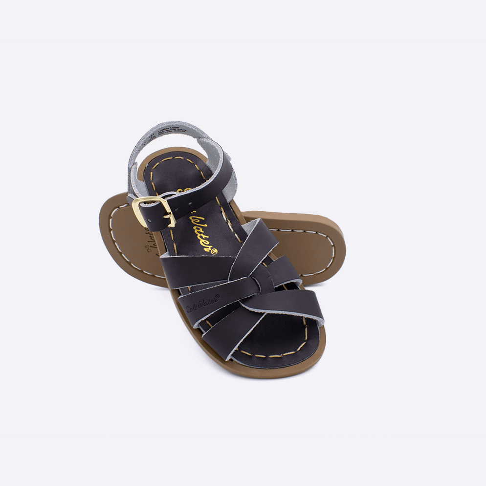 Two toddler sized 800 Original style sandals with brown straps and brown insoles.  One standing with the sole facing the camera. The second is laying diagonally over the top left edge of the sole.