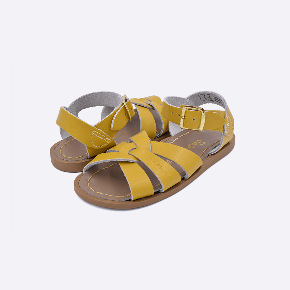 Two  toddler sized 800 Original style sandals with mustard straps and beige insoles. Both pushed together facing the camera diagonally.