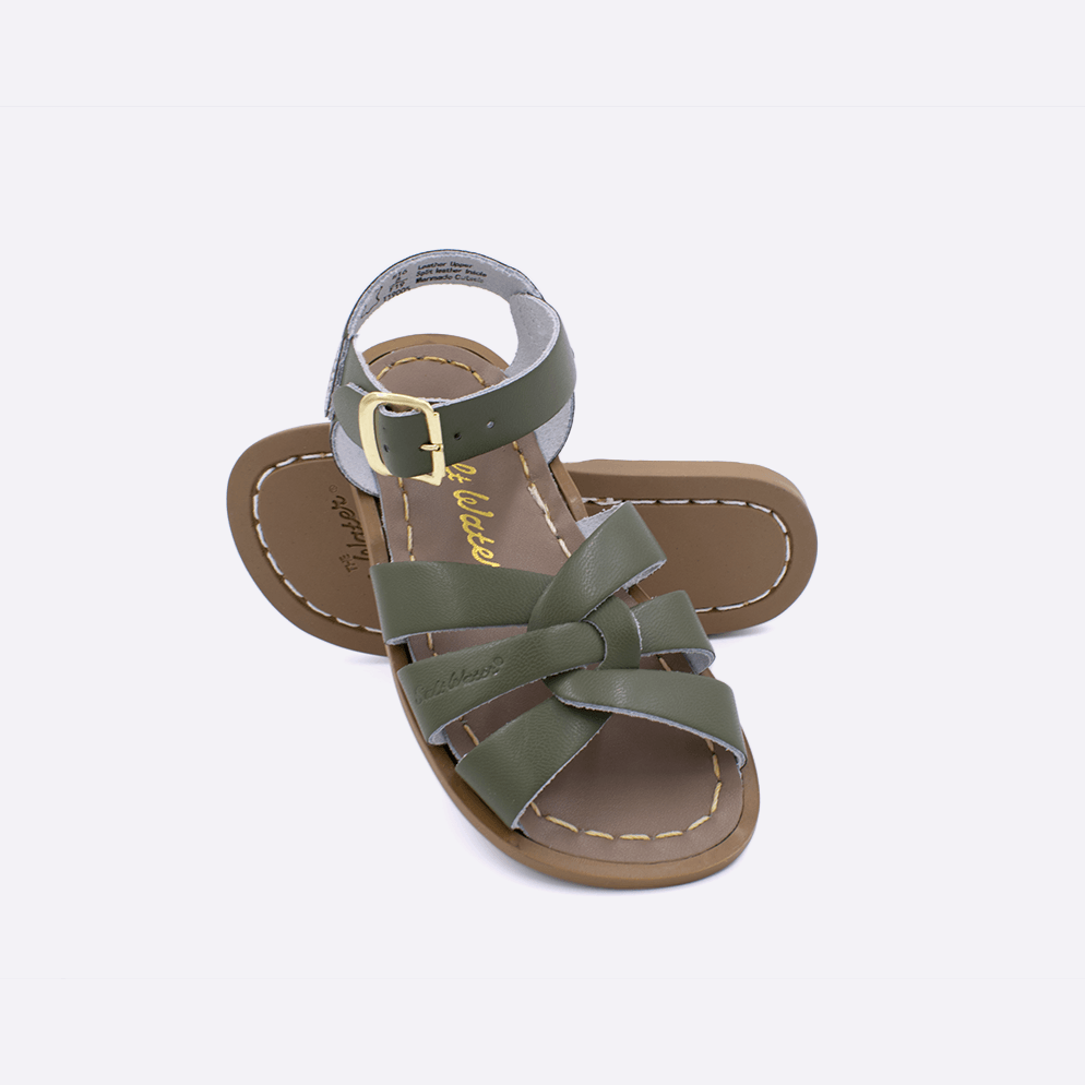 Two toddler sized 800 Original style sandals with olive straps and beige insoles.  One standing with the sole facing the camera. The second is laying diagonally over the top left edge of the sole.