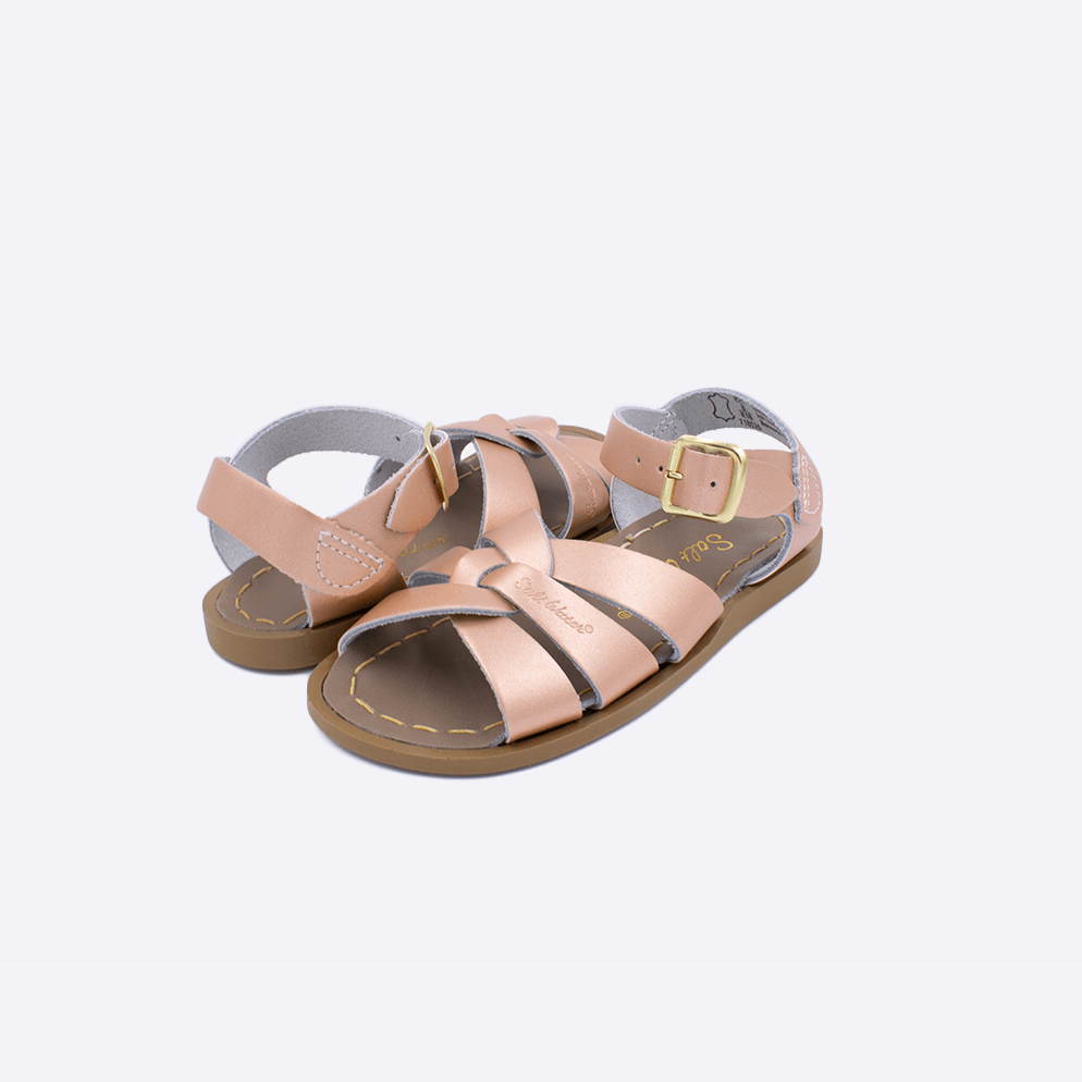 Two toddler sized 800 Original style sandals with rose gold straps and beige insoles. Both pushed together facing the camera diagonally.
