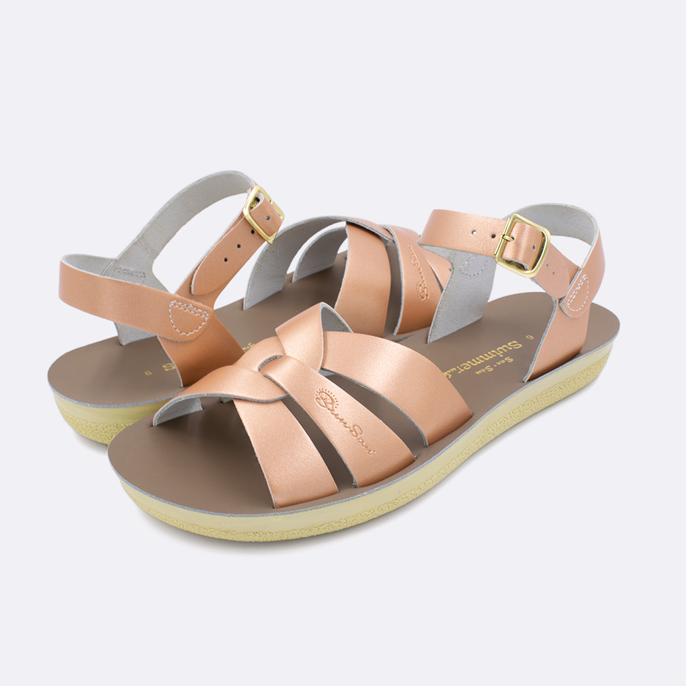 Two women's sized 8000 Swimmer style sandals with rose gold straps and beige insoles. Both pushed together facing the camera diagonally.